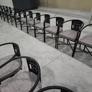 Gray Laser-Cut Metal Restaurant Chairs With Powder-Coated Finish.