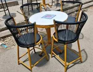 Outdoor Woven Chairs With Gold Metal Table.