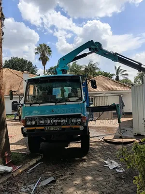 Trucks With Uplifting Cranes Are Available for Jobs and Delivery