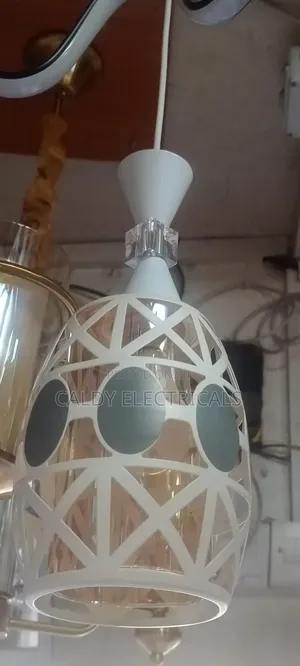 Glass and Metal Pendant Light With a White Geometric Overlay