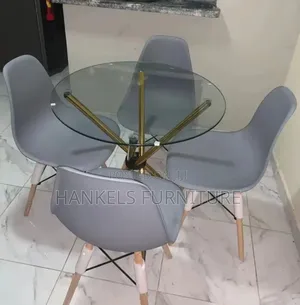 Round Glass Dining Table With Gray Eames Chairs – Modern Elegant