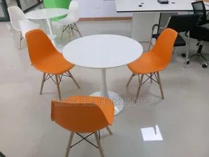White Coffee Dining Table With Orange Eame Chair