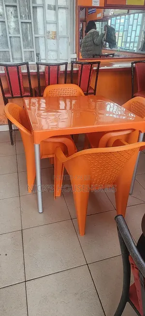 Four Plastic Chairs With a Square Plastic Table Set