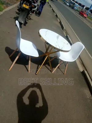 Golden Stand Marble Top Round Table and White Eames Chairs