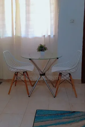 Round Table and Mesh Eames Chairs