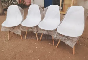 Four White Plastic Chairs With Wooden Leg