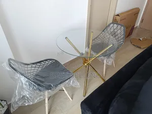 Golden Stands Round Table and Mesh Eames Chairs