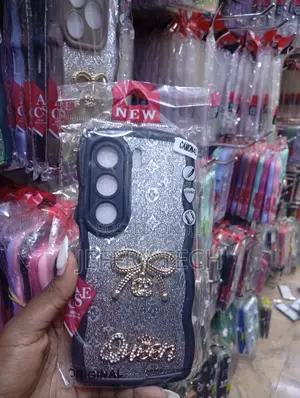 Tecno Camon 40, Silver Glitter Finish, a Bow Emblem Case.