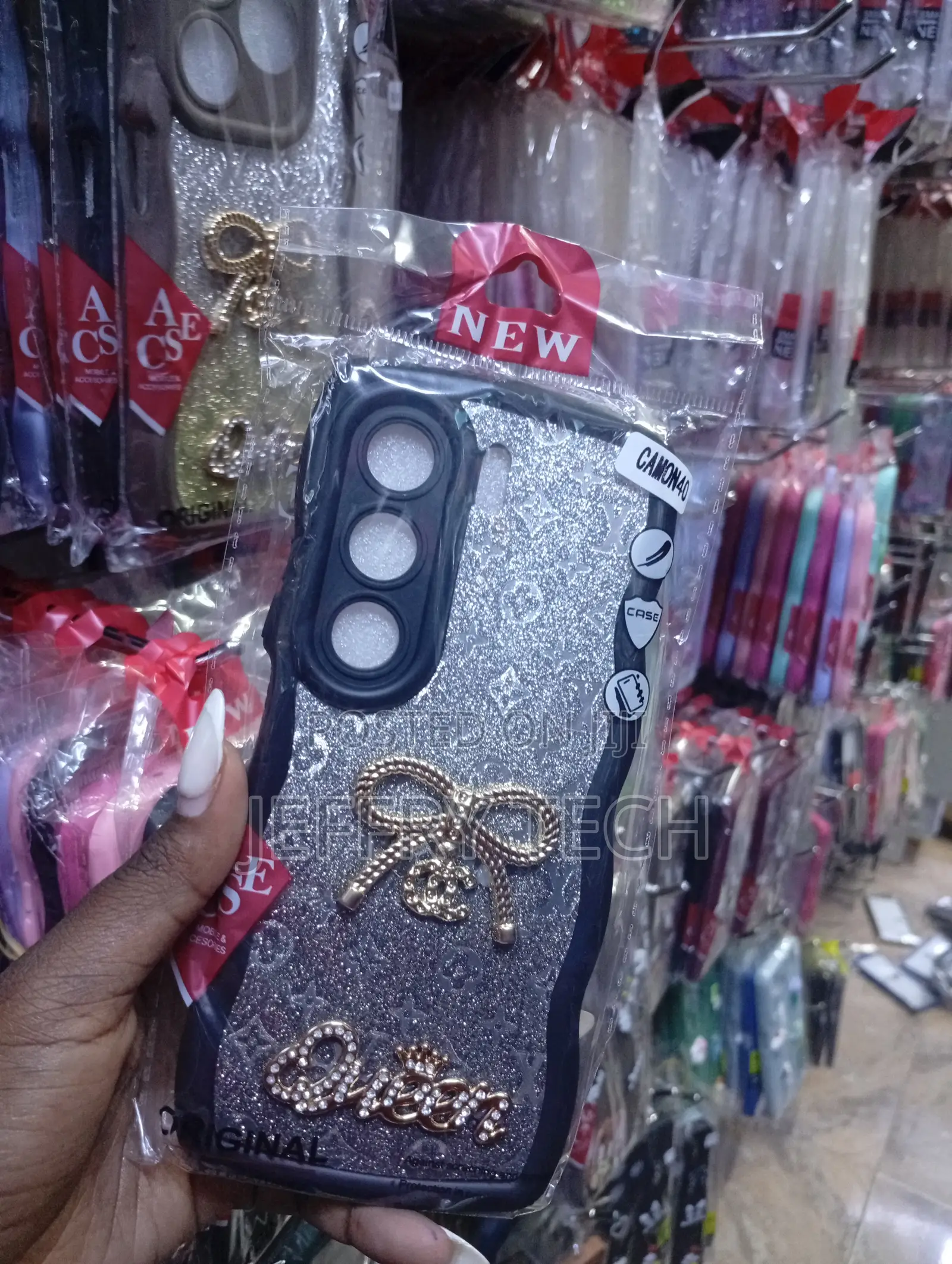 Tecno Camon 40, Silver Glitter Finish, a Bow Emblem Case.