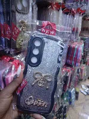 Tecno Camon 40, Silver Glitter Finish, a Bow Emblem Case.