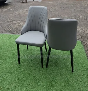 Pair of Modern Grey Upholstered Dining Chairs With Black Metal Legs