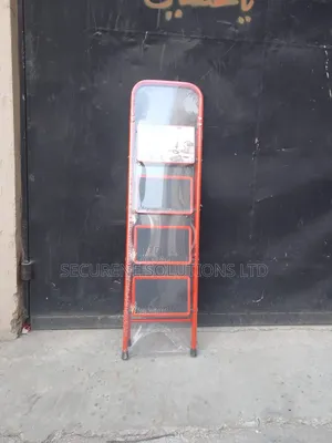 A 4-Step Foldable Steel Ladder With a Red Frame