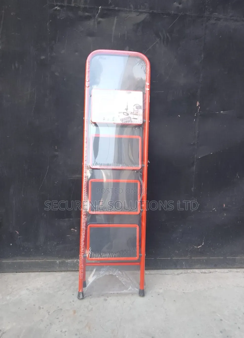 A 4-Step Foldable Steel Ladder With a Red Frame