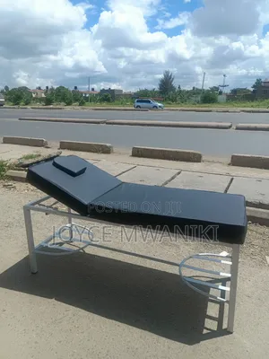 Massage Bed With Black Mattress And White Coated Frame