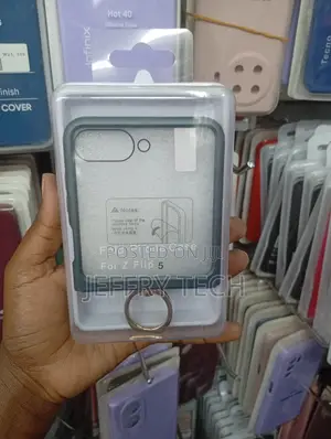 Samsung Galaxy Z Flip 5 With a Dark Grey Border and a Ring Holder.