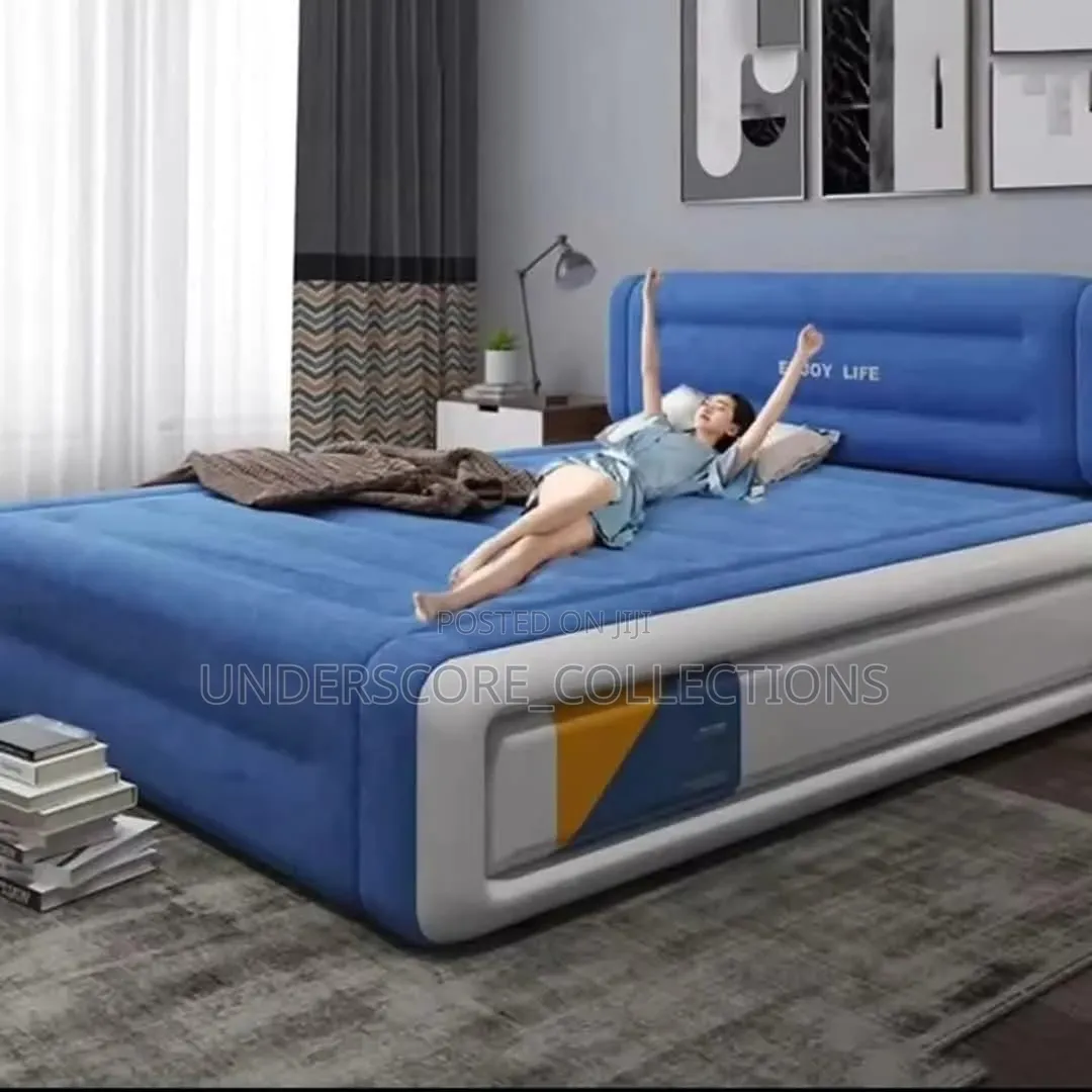 Blue and White Inflatable Air Bed With a Built-in Headrest.