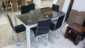 6-Seater Dining Set. Rectangular Glass Table With Metallic Stands.