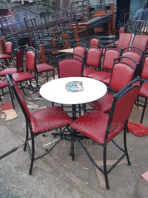 A Set of Maroon Hotel Chairs and a White Table
