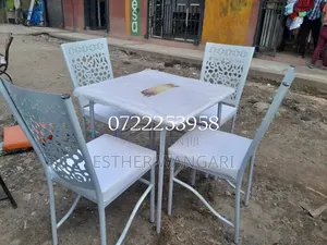 A Set of White Hotel Chairs and a Table