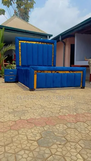 5x6 Blue Tufted Bed With a Gold Accents and a Bedside Drawer
