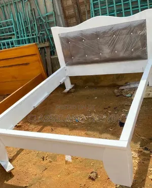 White Wooden Bed With an Upholstered Headboard