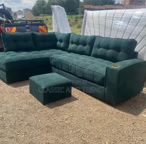 Spacious Dark Green L-Shaped Sofa With an Ottoman