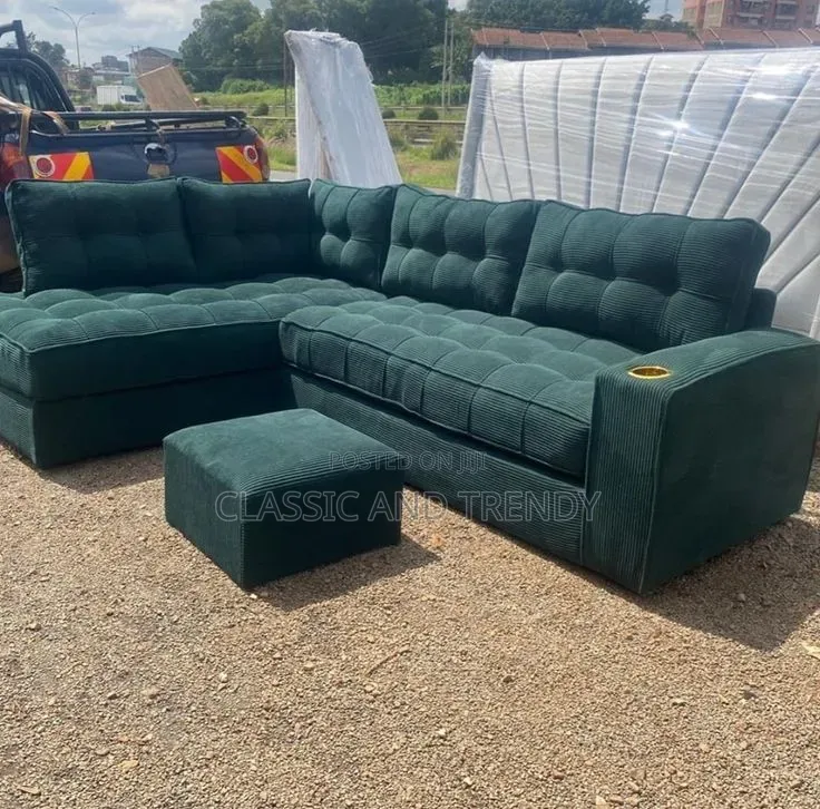 Spacious Dark Green L-Shaped Sofa With an Ottoman
