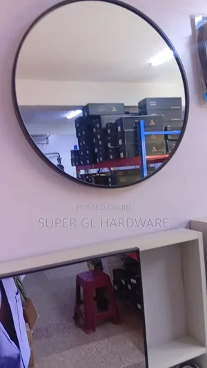 A Black Round Mirror With Black Metal Frame