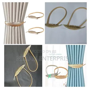 A Pair of Feather Shaped Elastic, Metallic Curtain Buckles *