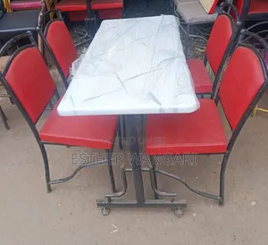 A Set of Four Red Chairs and White Table