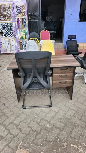 This Set of a Dark Walnut Desk Paired With a Black Mesh Chair.