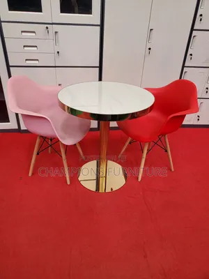 Gold Pedestal Table With Molded Shell Armchairs