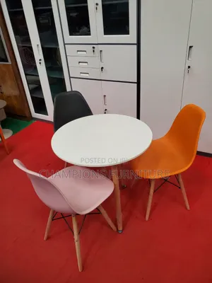 White Round Table and Eames Chairs